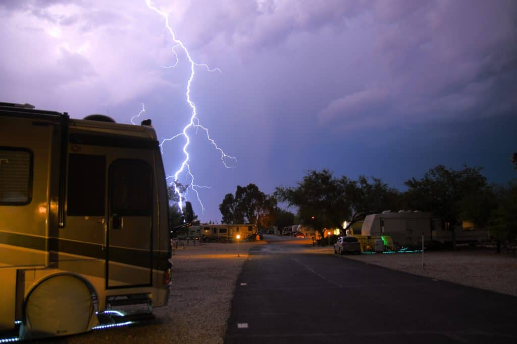 motorhome with a bolt of lightning behind it