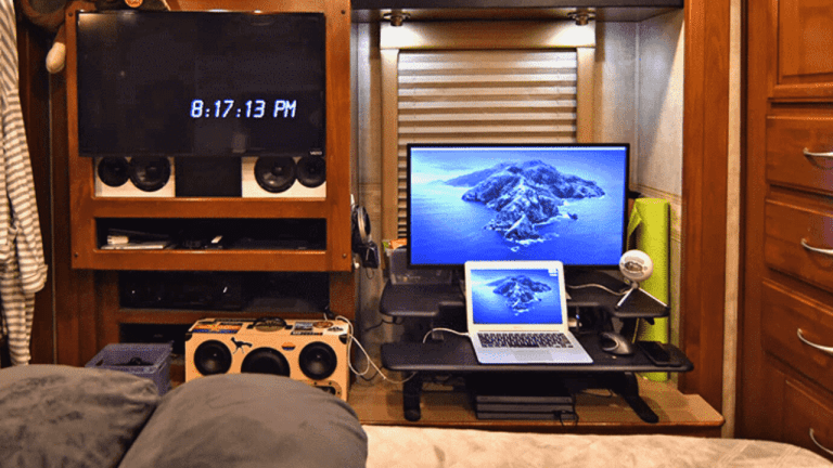 laptop and external monitor setup in the bedroom of a motorhome