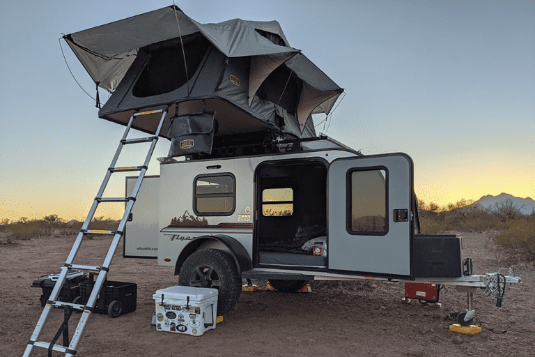 rooftop tent on an offroad trailer with a sunset in the background