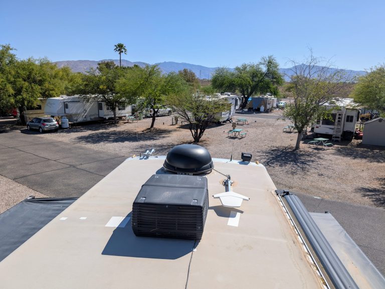 view from the roof of a Class A diesel pusher in an rv park with mountains in the background