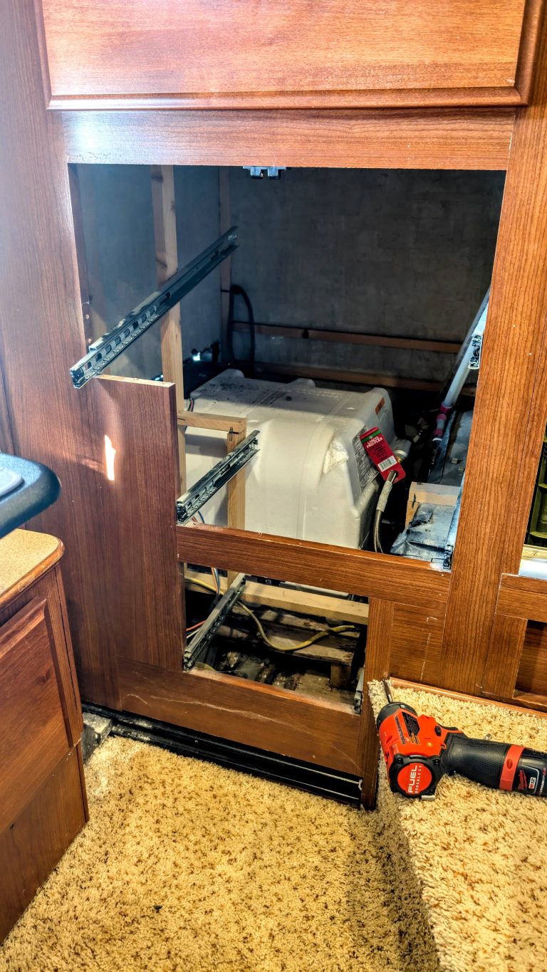 Our Rv Water Heater Failed (Again), So We Went Tankless 4 open compartment revealing rv water heater